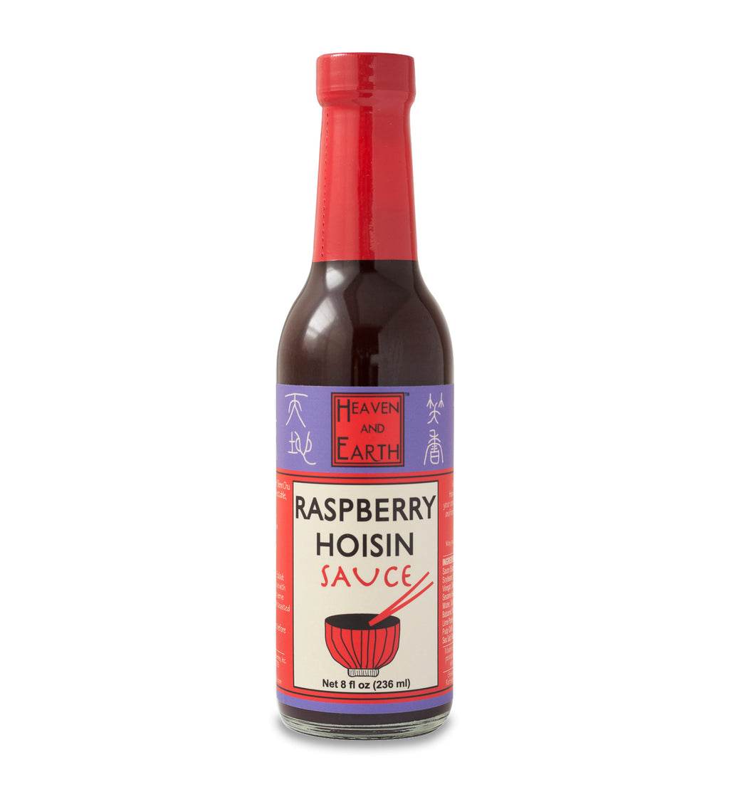 Glass ring neck bottle of raspberry hoisin sauce on a white background. The bottle is covered in a purple, red, and off-white label that says, “Heaven and Earth Raspberry Hoisin Sauce Net 8 oz (236ml)”. 