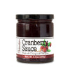 Short, lidded jar full of cranberry sauce on white background. The jar is labeled, “Paradigm Cranberry Sauce Made with Orange and Port Wine – Net Weight 9.5oz (269g)”