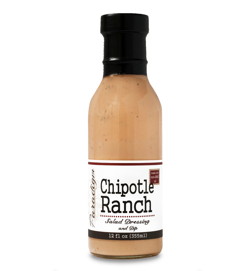 Glass ring neck bottle filled with Chipotle Ranch dressing on white background. The bottle is labeled, “Paradigm Chipotle Ranch Salad Dressing and Dip – 12 fl oz (355ml)” and “Made with non-GMO oil”.