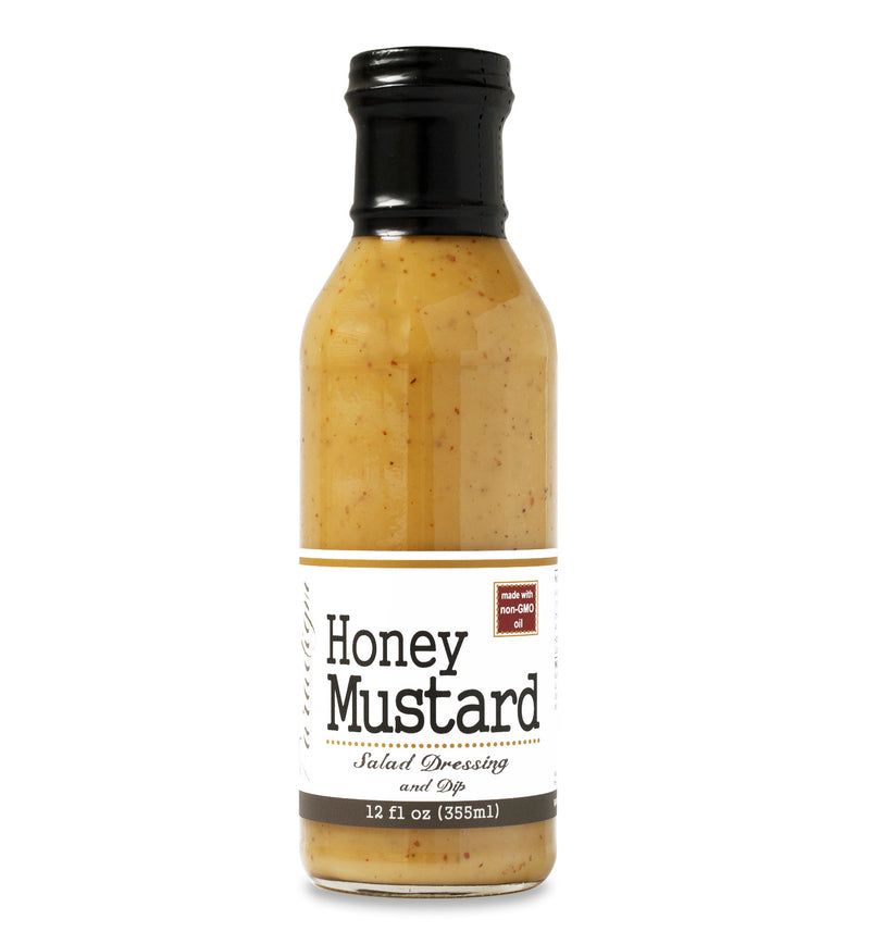 Glass ring neck bottle filled with Honey Mustard on white background. The bottle is labeled, “Paradigm Honey Mustard Salad Dressing and Dip – 12 fl oz (355 ml)”.