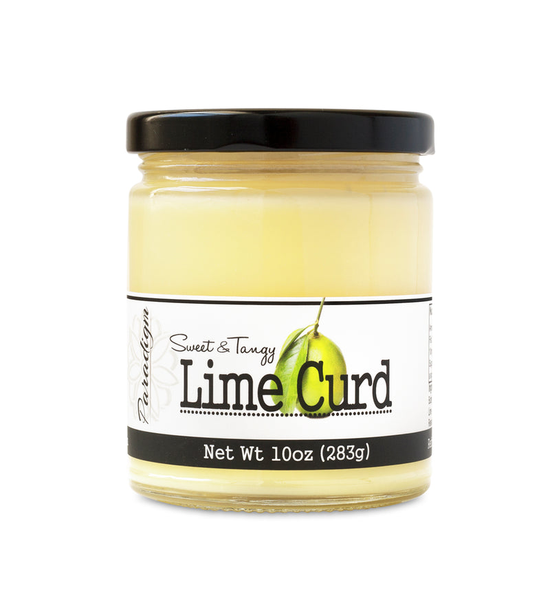 Short, lidded jar full of Lime Curd, on white background. The jar is labeled “Paradigm Sweet & Tangy Lime Curd– Net Weight 10oz (283g)” 