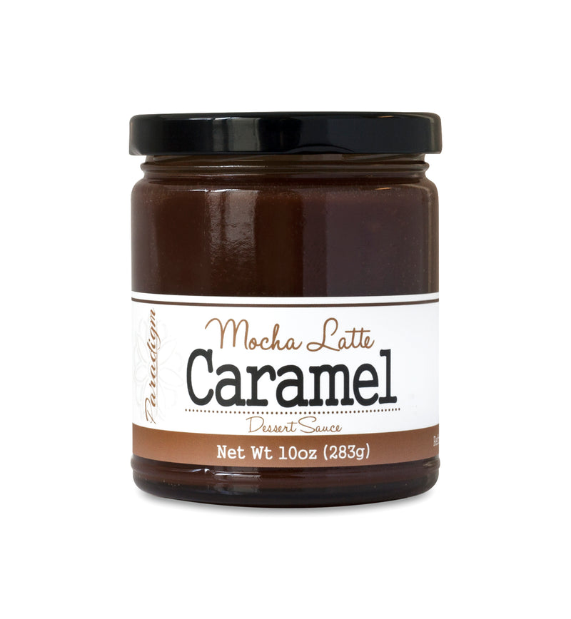 Short, lidded jar full of dark caramel sauce, on white background. The jar is labeled “Paradigm Mocha Latte Caramel Dessert Sauce – Net Weight 10oz (283g)” 