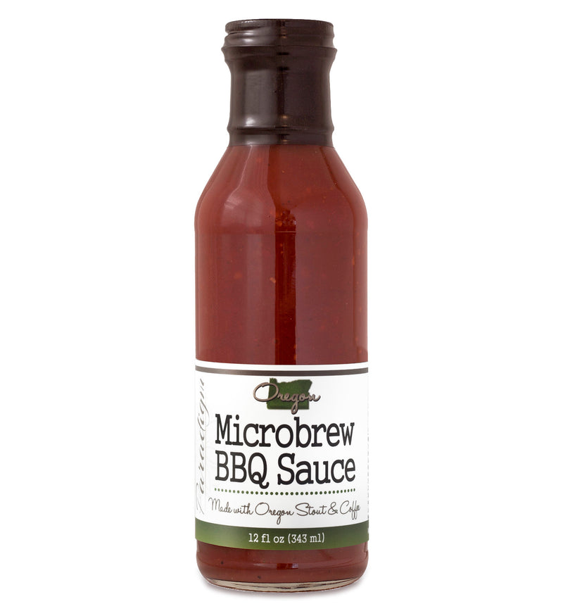 Glass ring neck bottle filled with BBQ sauce on white background. The bottle is labeled, “Paradigm Oregon Microbrew BBQ Sauce – Made with Oregon Stout & Coffee – 12 fl oz (355ml)”