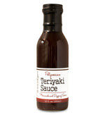 Glass ring neck bottle filled with Polynesian Teriyaki Sauce on white background. The bottle is labeled, “Paradigm Polynesian Teriyaki Sauce – Marinade and Dipping Sauce – 12 fl oz (355ml)”