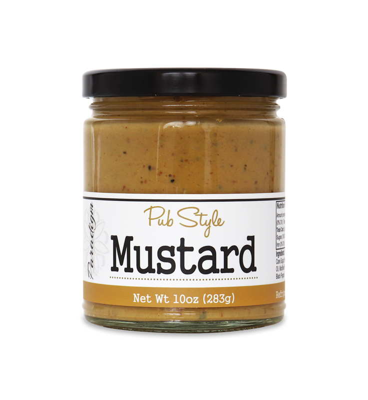 Short lidded jar full of pub mustard on white background. The jar is labeled, “Paradigm Pub Style Mustard – Net Weight 10oz (283g)”