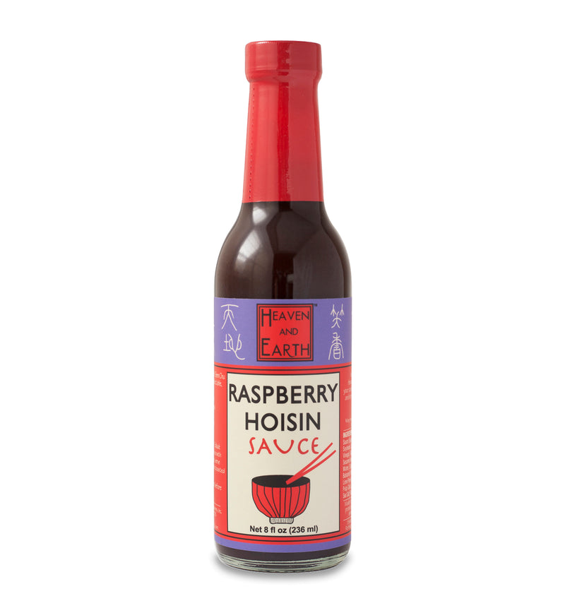 Glass ring neck bottle of raspberry hoisin sauce on a white background. The bottle is covered in a purple, red, and off-white label that says, “Heaven and Earth Raspberry Hoisin Sauce Net 8 oz (236ml)”. 