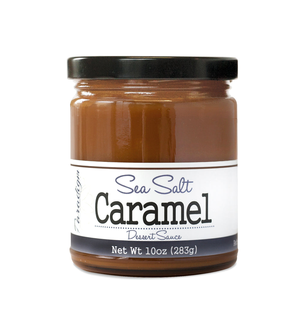 Short, lidded jar full of caramel sauce, on white background. The jar is labeled “Paradigm Mocha Latte Caramel Dessert Sauce – Net Weight 10oz (283g)” 