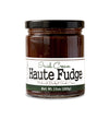Short, lidded jar full of fudge sauce, on white background. The jar is labeled “Paradigm Irish Cream Haute Fudge Made with Bailey’s Irish Cream – Net Weight 10oz (283g)” 