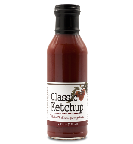 Glass ring neck bottle filled with ketchup on white background. The bottle is labeled, “Paradigm Classic Ketchup Made with all non-GMO ingredients – 12 fl oz (355ml)”.