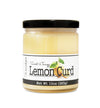 Short, lidded jar full of Lemon Curd, on white background. The jar is labeled “Paradigm Sweet & Tangy Lemon Curd– Net Weight 10oz (283g)” 