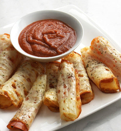 Rolled pizza appetizers on white square plate with small ceramic white bowl of pizza sauce
